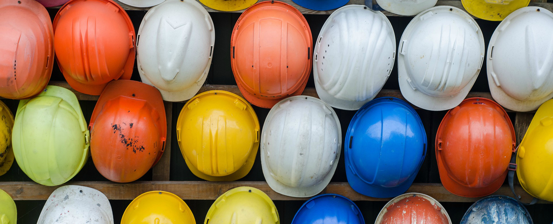 Hard hats hanging on a wall